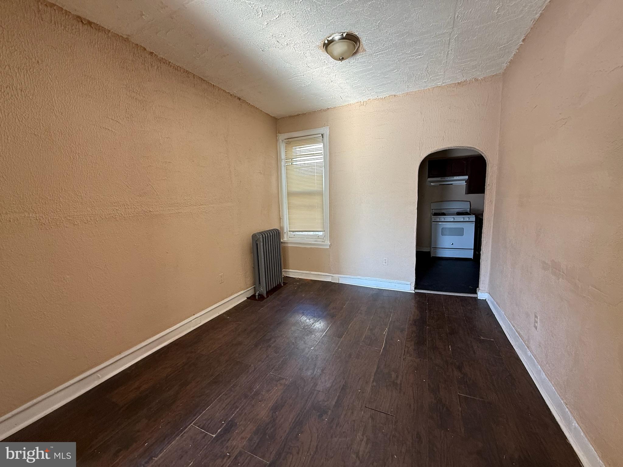 2413 West Indiana Avenue Philadelphia, PA 19132 - Photo 3 of 9 an empty room with wooden floor and natural light
