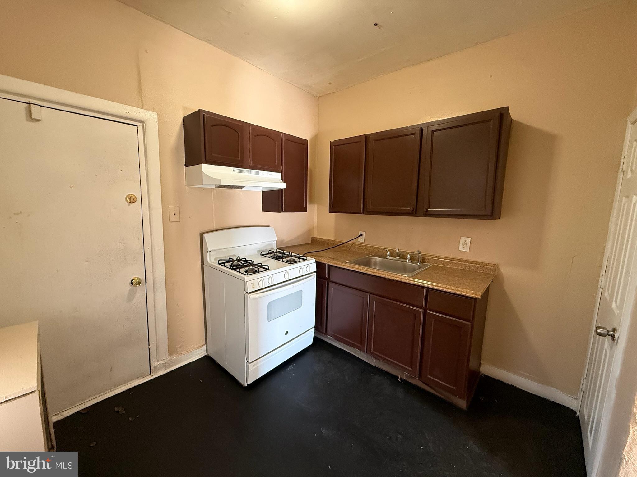 2413 West Indiana Avenue Philadelphia, PA 19132 - Photo 4 of 9 a kitchen with a stove and a refrigerator