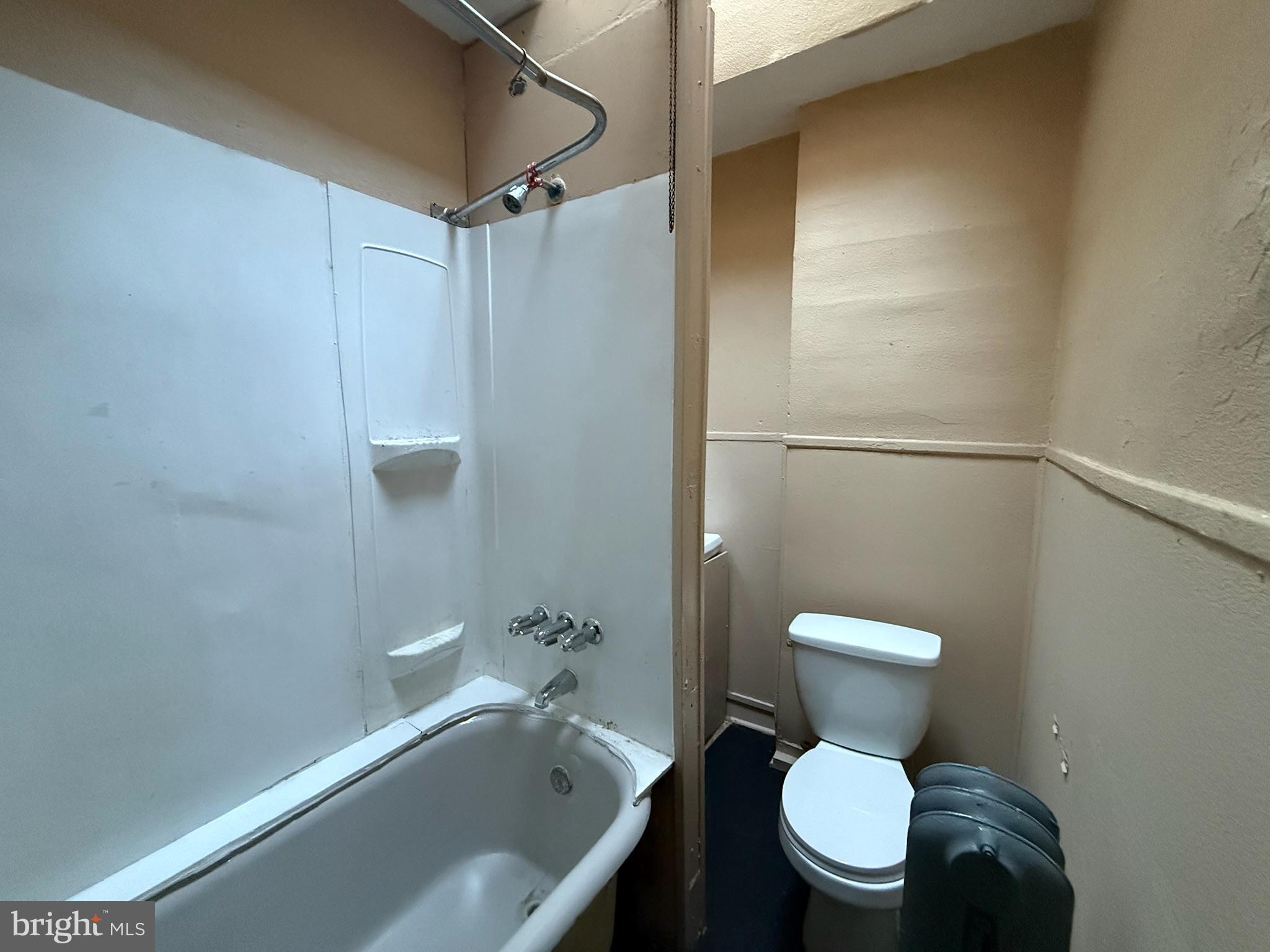 2413 West Indiana Avenue Philadelphia, PA 19132 - Photo 7 of 9 a white toilet sitting next to a bathtub