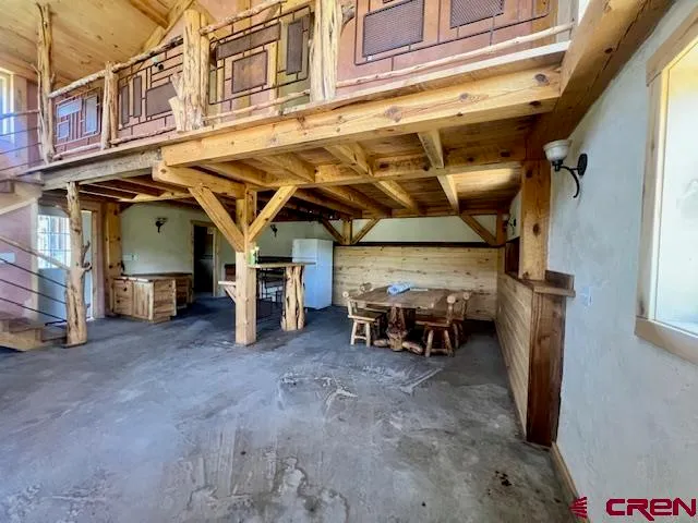 a view of a livingroom with furniture and a window
