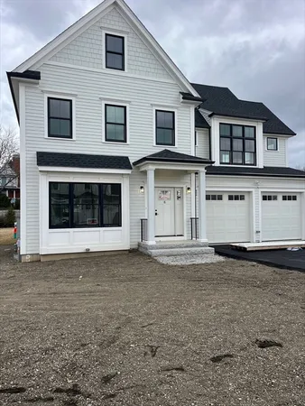 a view of a grey house with a yard