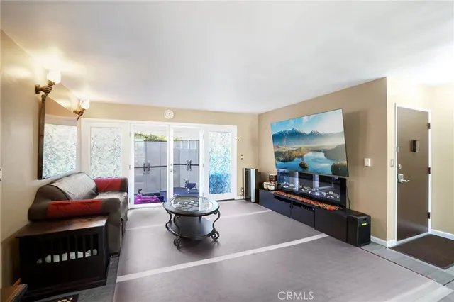 a living room with furniture and a floor to ceiling window