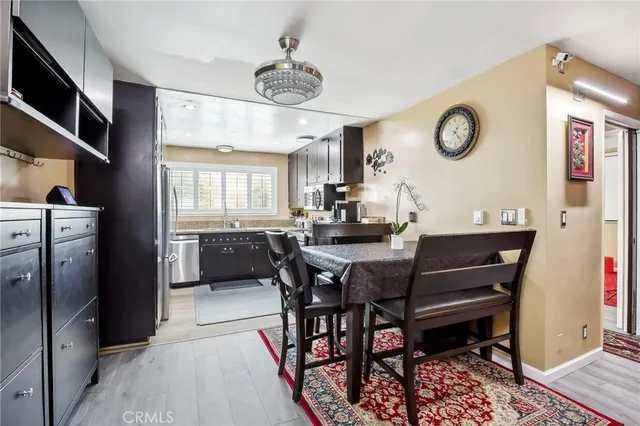 a view of a dining room and livingroom with furniture window and wooden floor