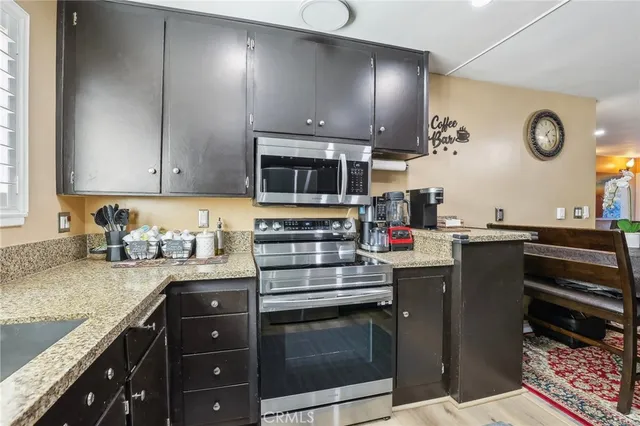a kitchen with stainless steel appliances granite countertop a stove and a sink
