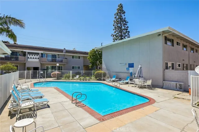 a view of a house with swimming pool and sitting area