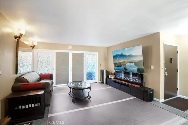 a living room with furniture and a floor to ceiling window