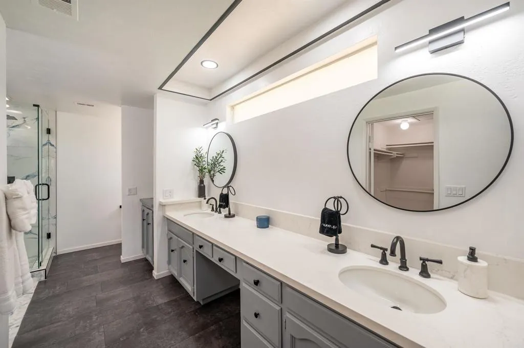 26086 Bear Valley Heights Road Valley Center, CA 92082 - Photo 43 of 65 a bathroom with a double vanity sink and a mirror