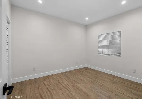 a view of a room with wooden floor and windows