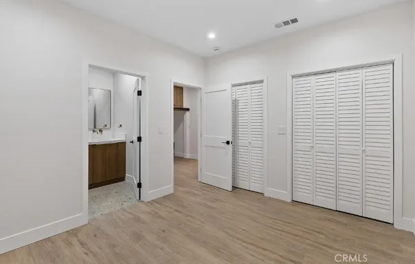 an empty room with closet and a window