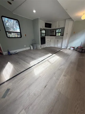a view of a livingroom with furniture and a flat screen tv