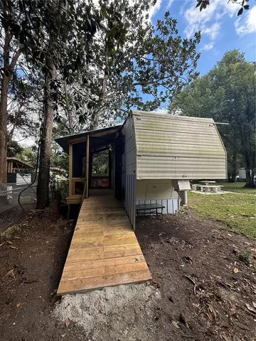 a backyard of a house with table and chairs
