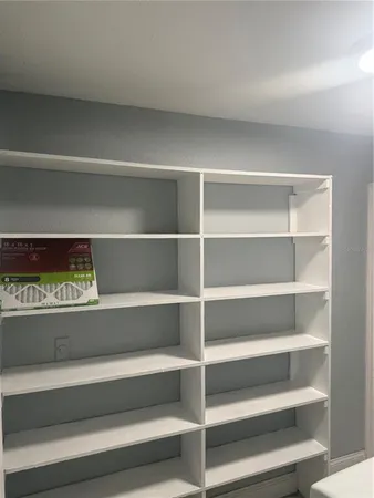 a view of walk in closet with empty racks