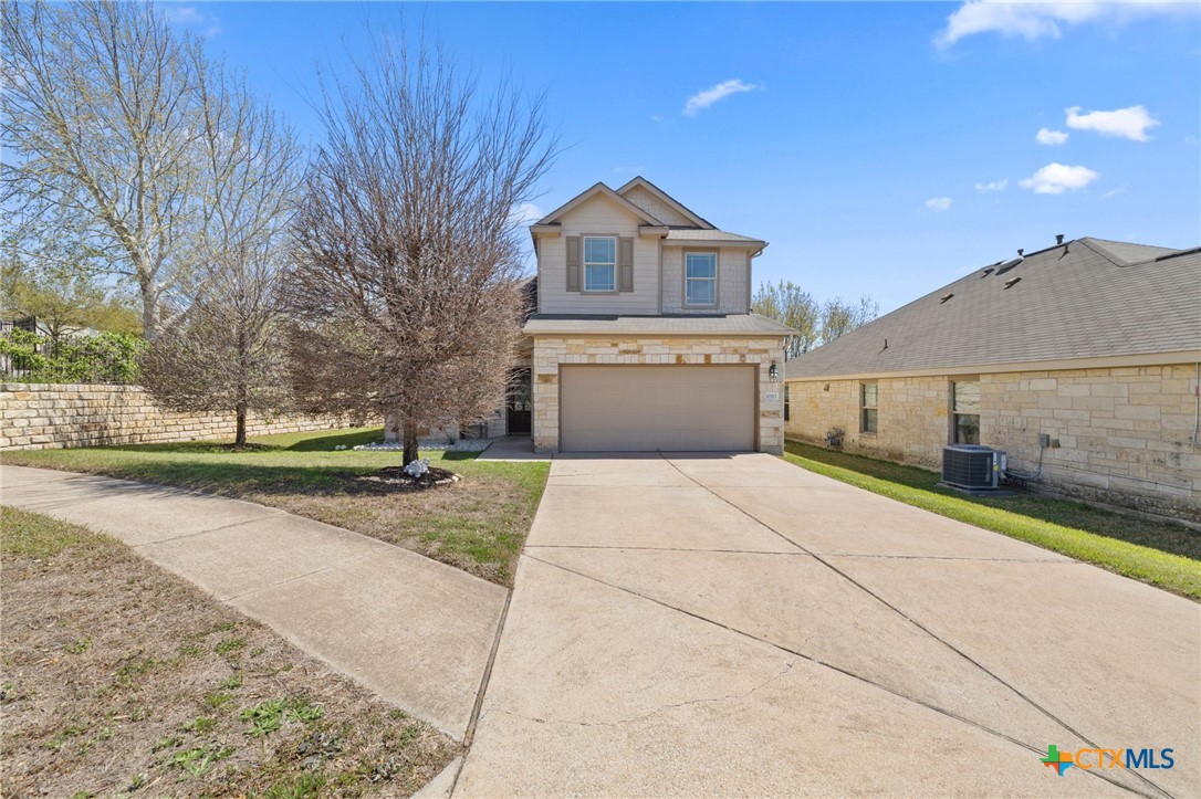 10113 Copper Ridge Cove Austin, TX 78747 - Photo 32 of 32 a front view of a house with a yard and garage