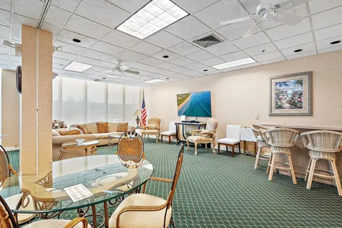 a living room with lots of furniture and a large window