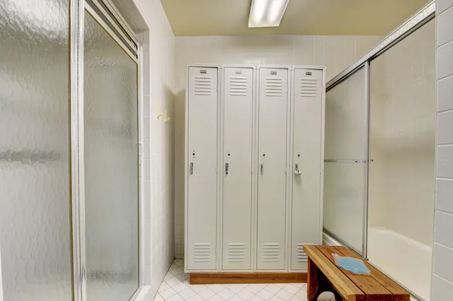 a bathroom with a shower and a mirror