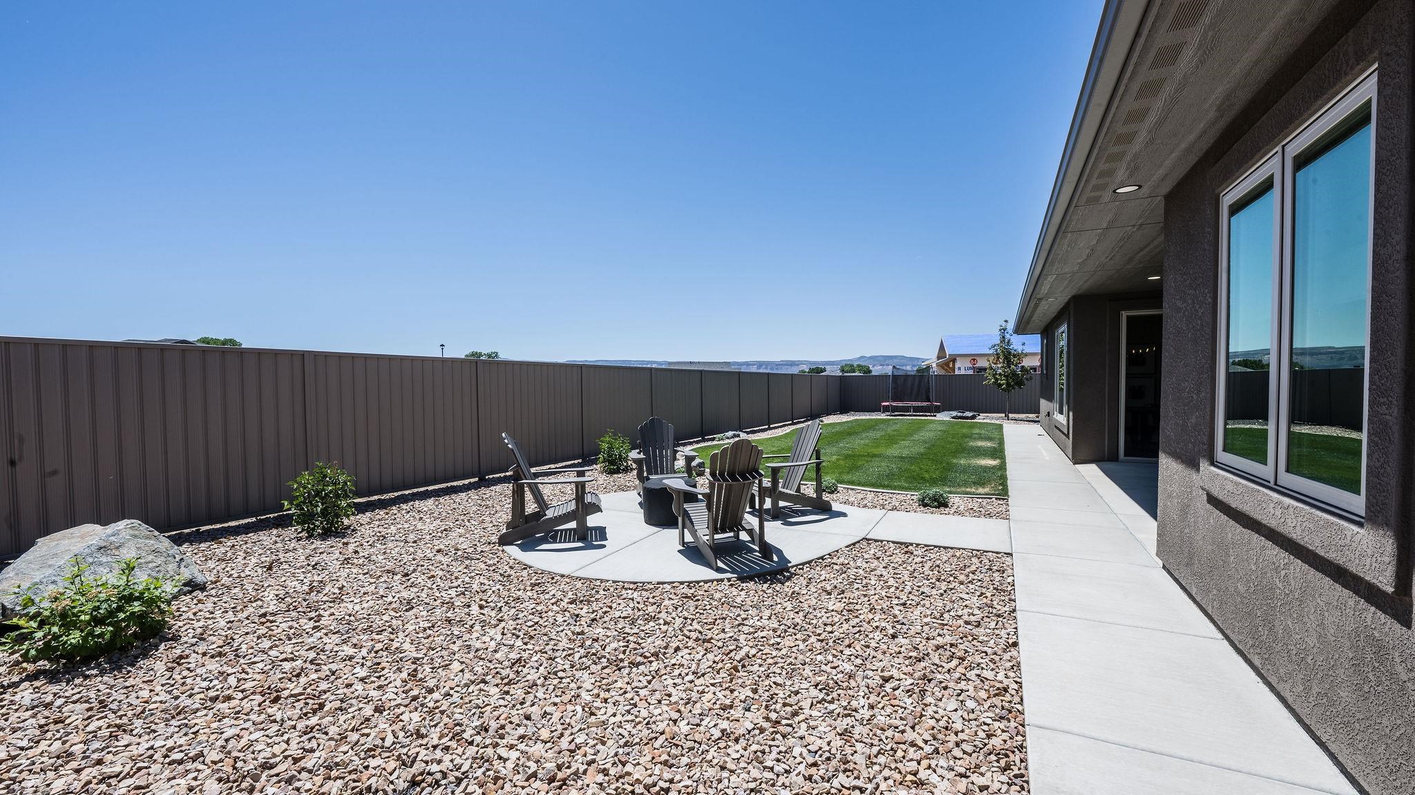 2639 Emerald Ridge Lane Grand Junction, CO 81506 - Photo 38 of 42 a backyard of a house with table and chairs