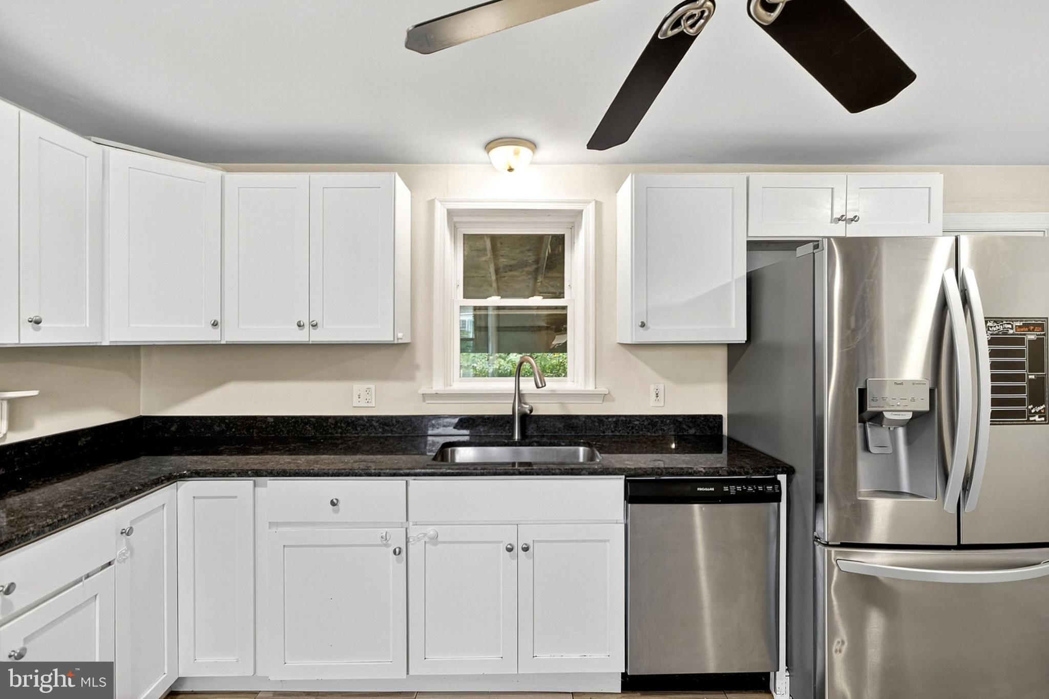 138 Diamond Street Hatfield, PA 19440 - Photo 19 of 33 a kitchen with a refrigerator and white cabinets