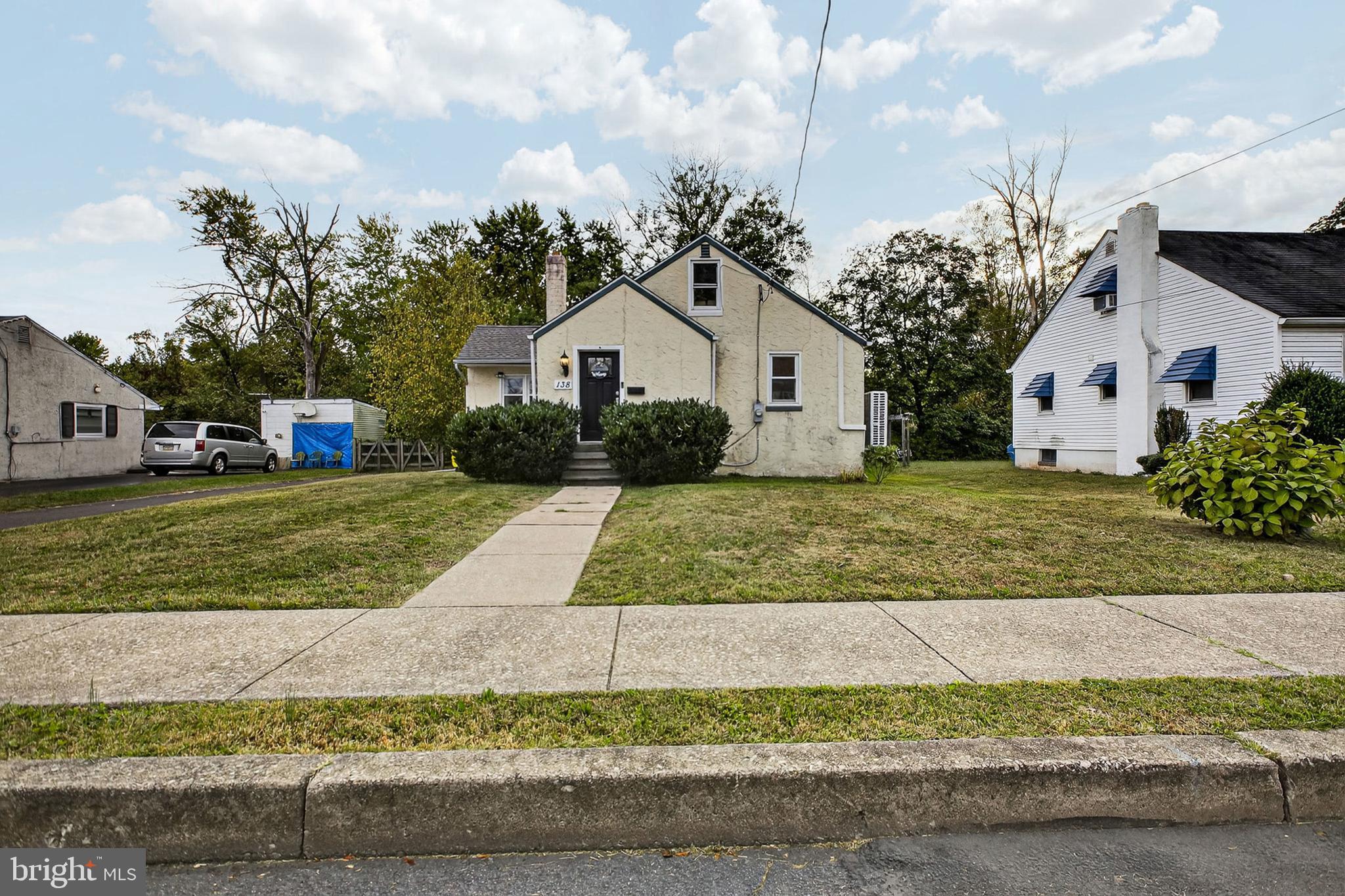 138 Diamond Street Hatfield, PA 19440 - Photo 4 of 33 a view of a white house with a yard and large trees