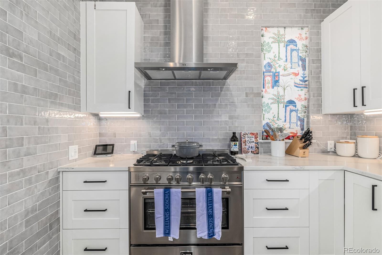 a kitchen with stainless steel appliances a stove and a sink