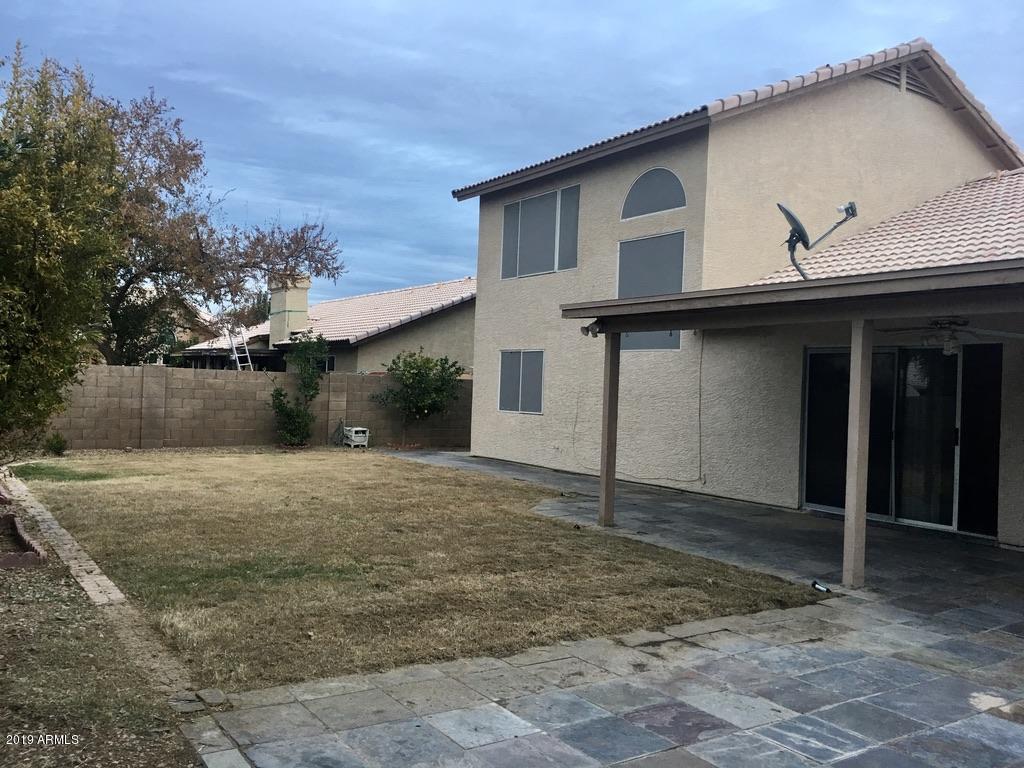 844 North Granite Street Gilbert, AZ 85234 - Photo 11 of 12 a front view of a house with a yard and garage