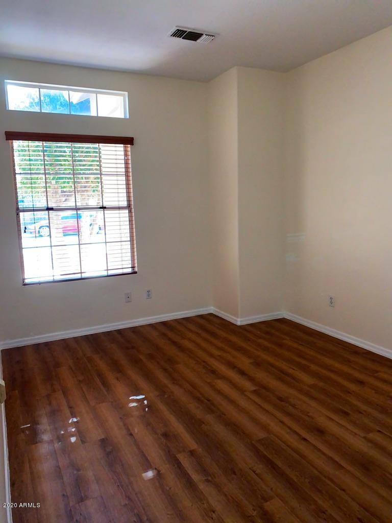 844 North Granite Street Gilbert, AZ 85234 - Photo 5 of 12 a view of an empty room with wooden floor and a window