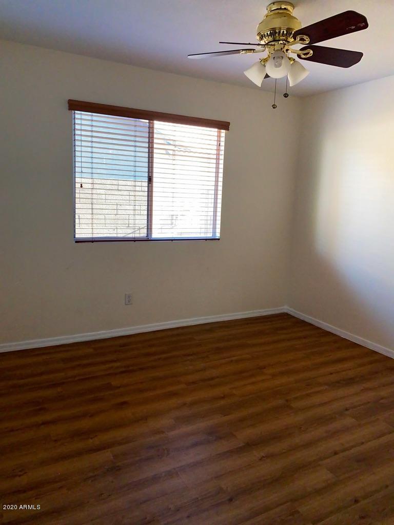 844 North Granite Street Gilbert, AZ 85234 - Photo 7 of 12 a view of an empty room with wooden floor and a window