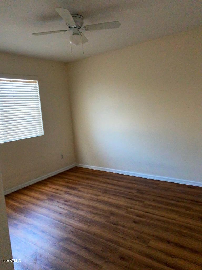 844 North Granite Street Gilbert, AZ 85234 - Photo 8 of 12 an empty room with wooden floor and windows