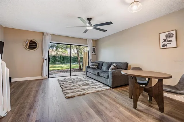 a living room with furniture tv and a flat screen tv