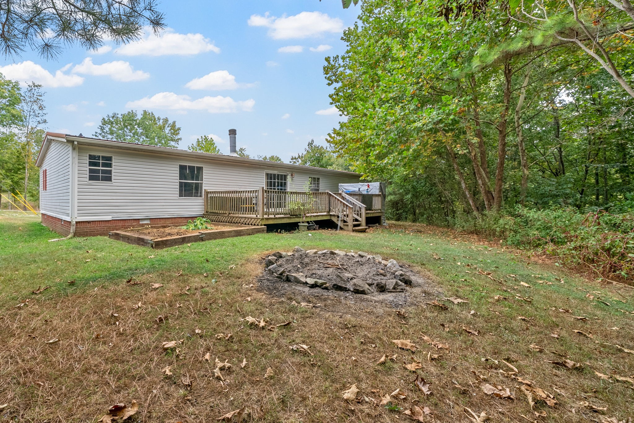 242 Barn Circle Road Big Rock, TN 37023 - Photo 30 of 40 a front view of a house with a garden and trees