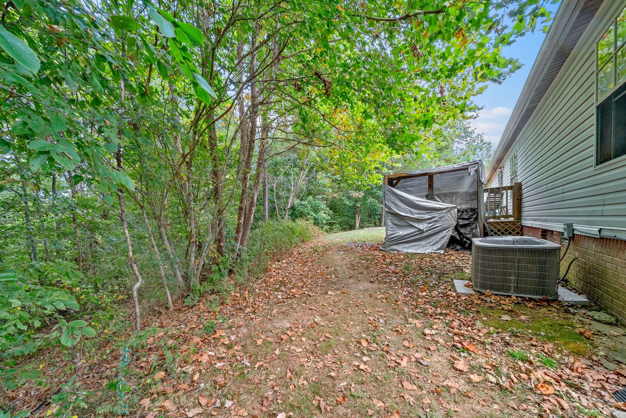 242 Barn Circle Road Big Rock, TN 37023 - Photo 32 of 40 a backyard of a house with outdoor seating