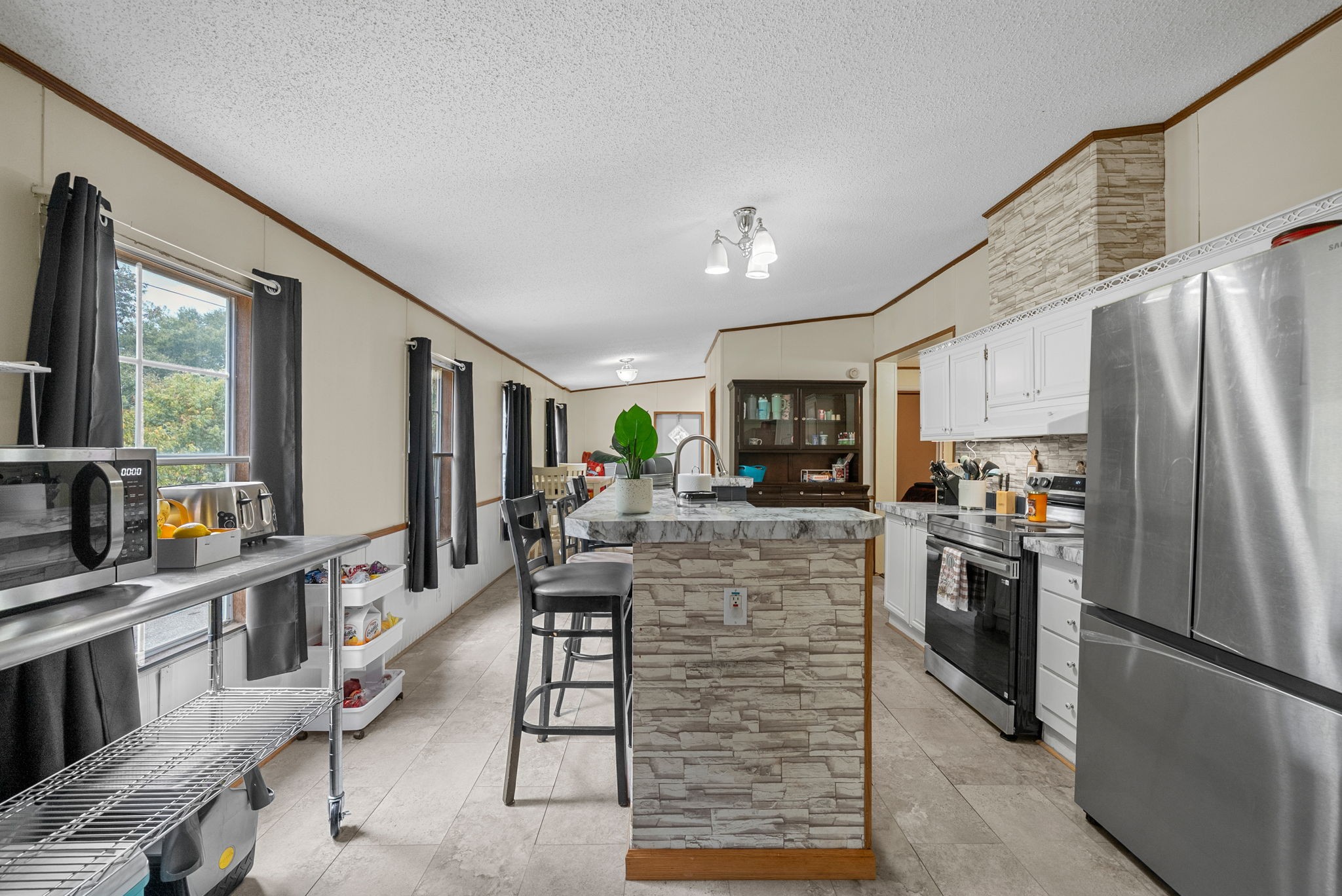 242 Barn Circle Road Big Rock, TN 37023 - Photo 8 of 40 a kitchen with stainless steel appliances kitchen island granite countertop a refrigerator and a stove