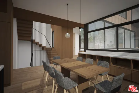 a view of a living room with furniture and large windows