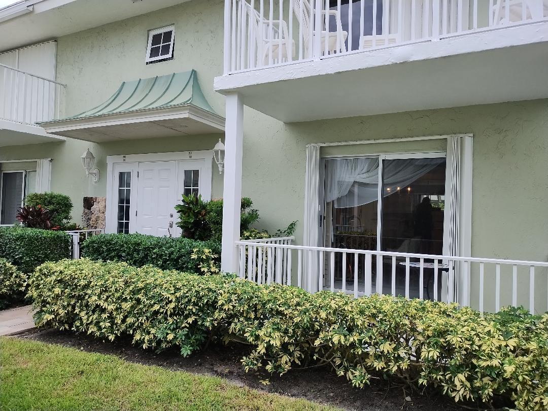 5500 Old Ocean Boulevard, Unit 104 Ocean Ridge, FL 33435 - Photo 16 of 19 a view of a house with a small yard and flower plants