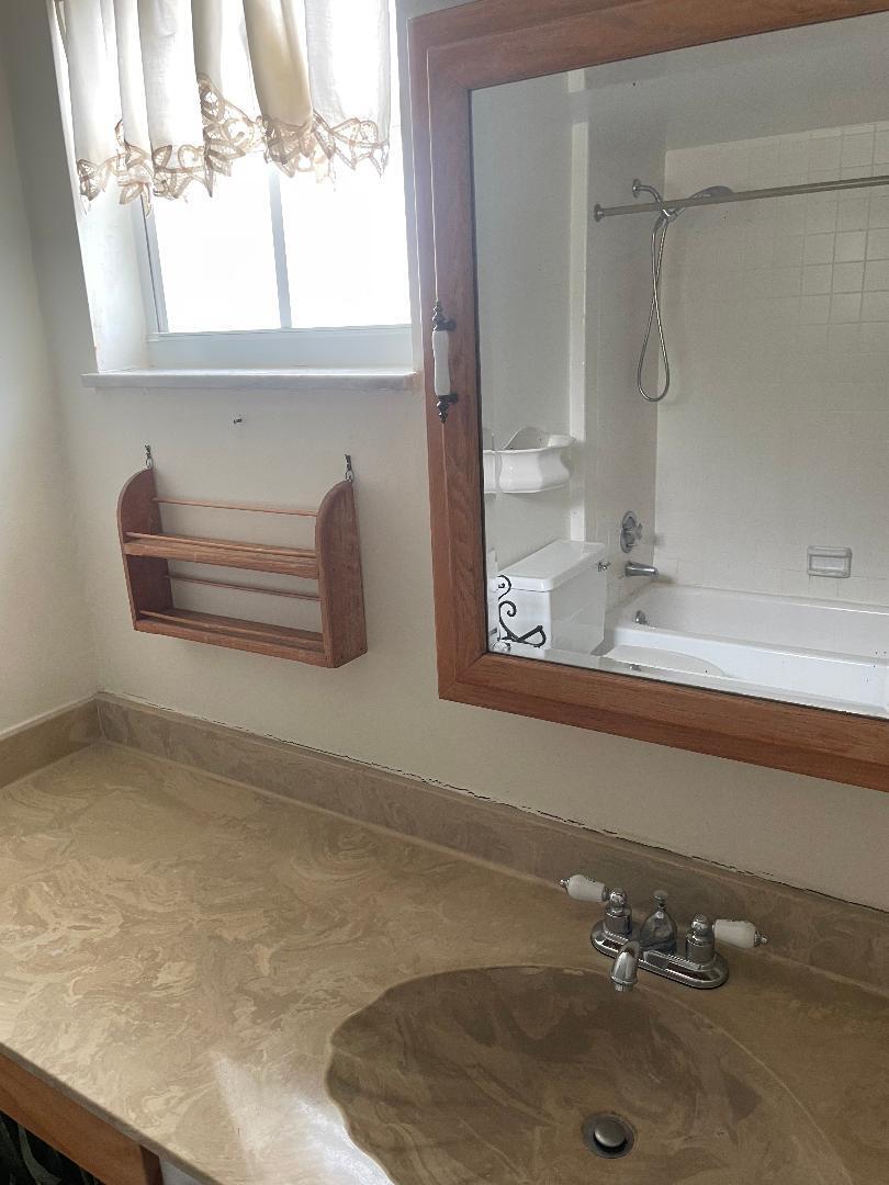 5500 Old Ocean Boulevard, Unit 104 Ocean Ridge, FL 33435 - Photo 18 of 19 a bathroom with a sink and a mirror