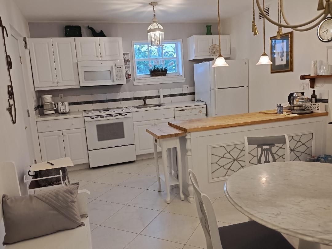 5500 Old Ocean Boulevard, Unit 104 Ocean Ridge, FL 33435 - Photo 19 of 19 a kitchen with a stove a sink and a refrigerator