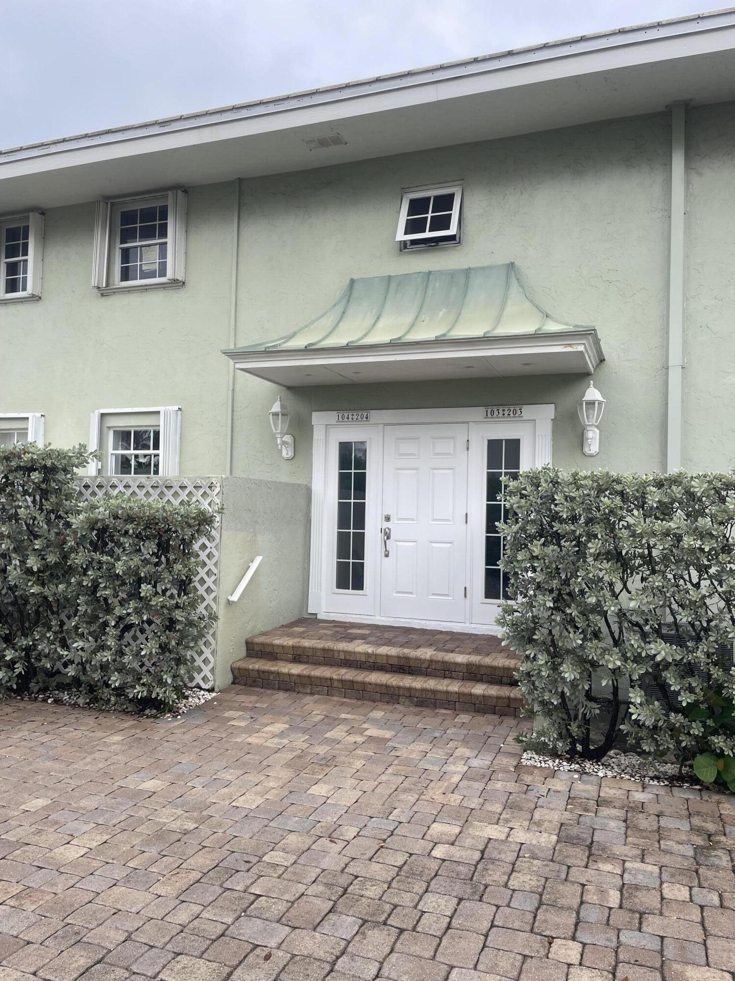 5500 Old Ocean Boulevard, Unit 104 Ocean Ridge, FL 33435 - Photo 4 of 19 a front view of a house with a garage