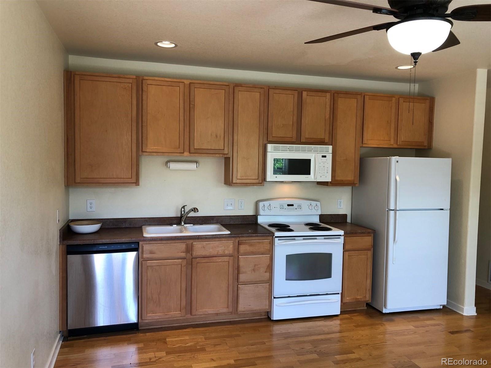 2389 South High Street, Unit 2 Denver, CO 80210 - Photo 1 of 1 a kitchen with stainless steel appliances granite countertop a stove a sink dishwasher and a refrigerator
