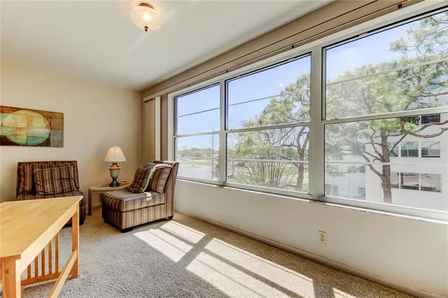a bedroom with furniture and a large window