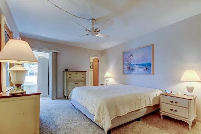 a bedroom with a bed and dresser with mirror