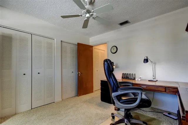 a view of a workspace with furniture and a chandelier