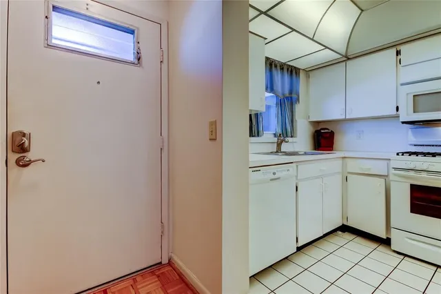 a kitchen with a sink cabinets and stainless steel appliances