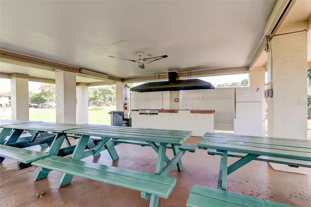 a kitchen with a sink a window and chairs