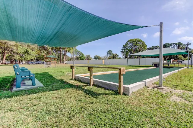 a view of an house with backyard space and a tree