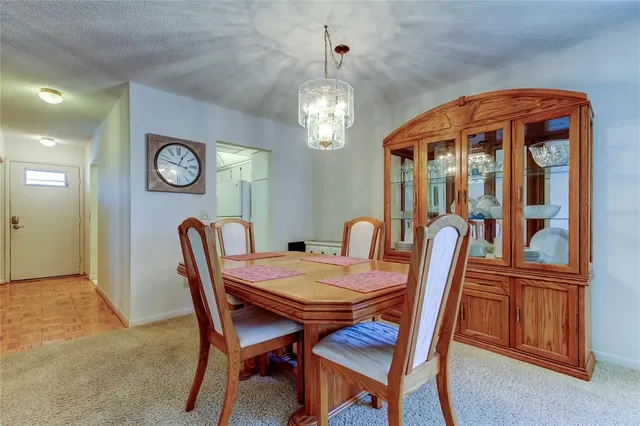 a view of a dining room with furniture and a chandelier