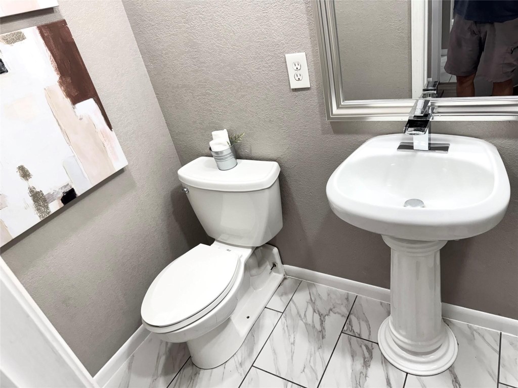 903 Roper Street Houston, TX 77034 - Photo 14 of 18 a bathroom with a toilet sink and mirror