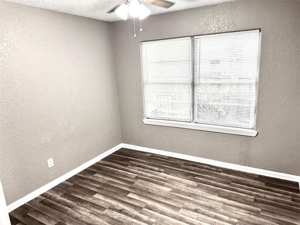 903 Roper Street Houston, TX 77034 - Photo 16 of 18 a view of a bedroom with wooden floor and fan