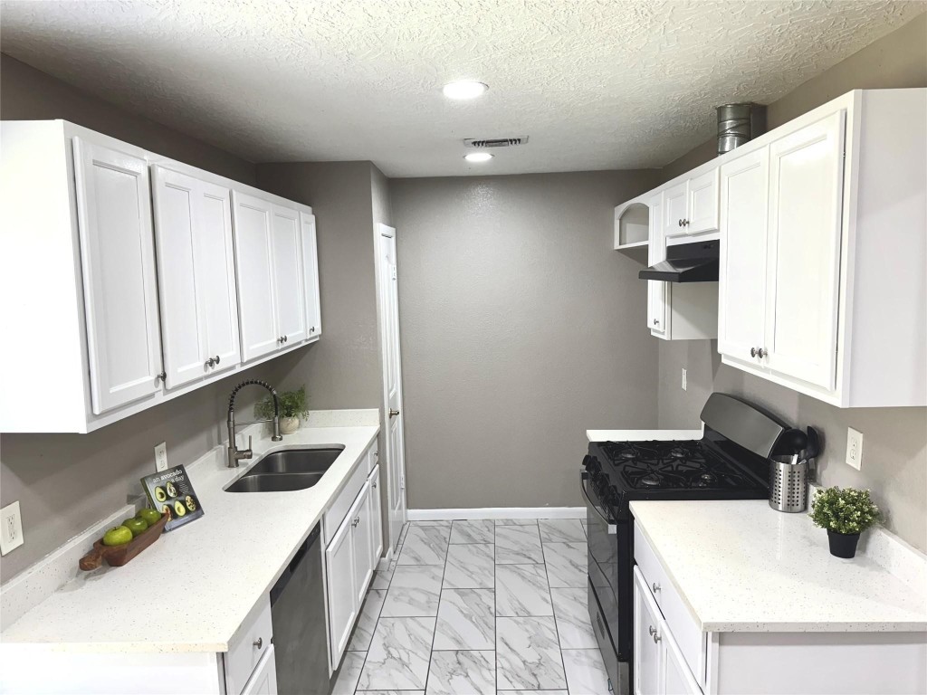 903 Roper Street Houston, TX 77034 - Photo 7 of 18 a kitchen with granite countertop a sink a stove and cabinets