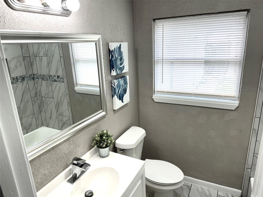 903 Roper Street Houston, TX 77034 - Photo 9 of 18 a bathroom with a sink a toilet and tub