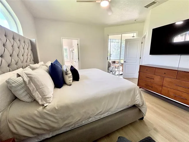 a bedroom with a bed and a flat screen tv