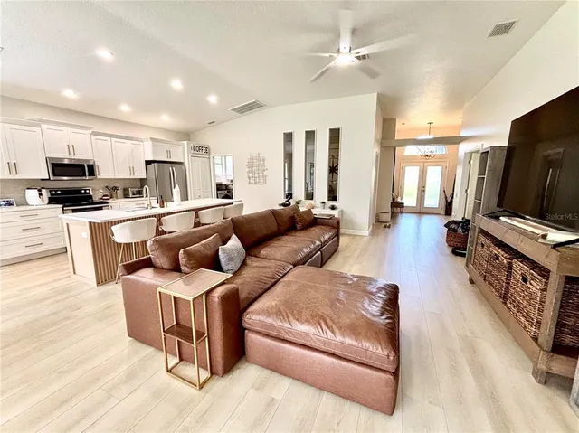a living room with furniture wooden floor and a flat screen tv